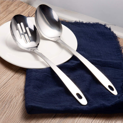 IMEEA stainless steel serving spoons arranged on a dining plate with a polished finish for stylish food presentation