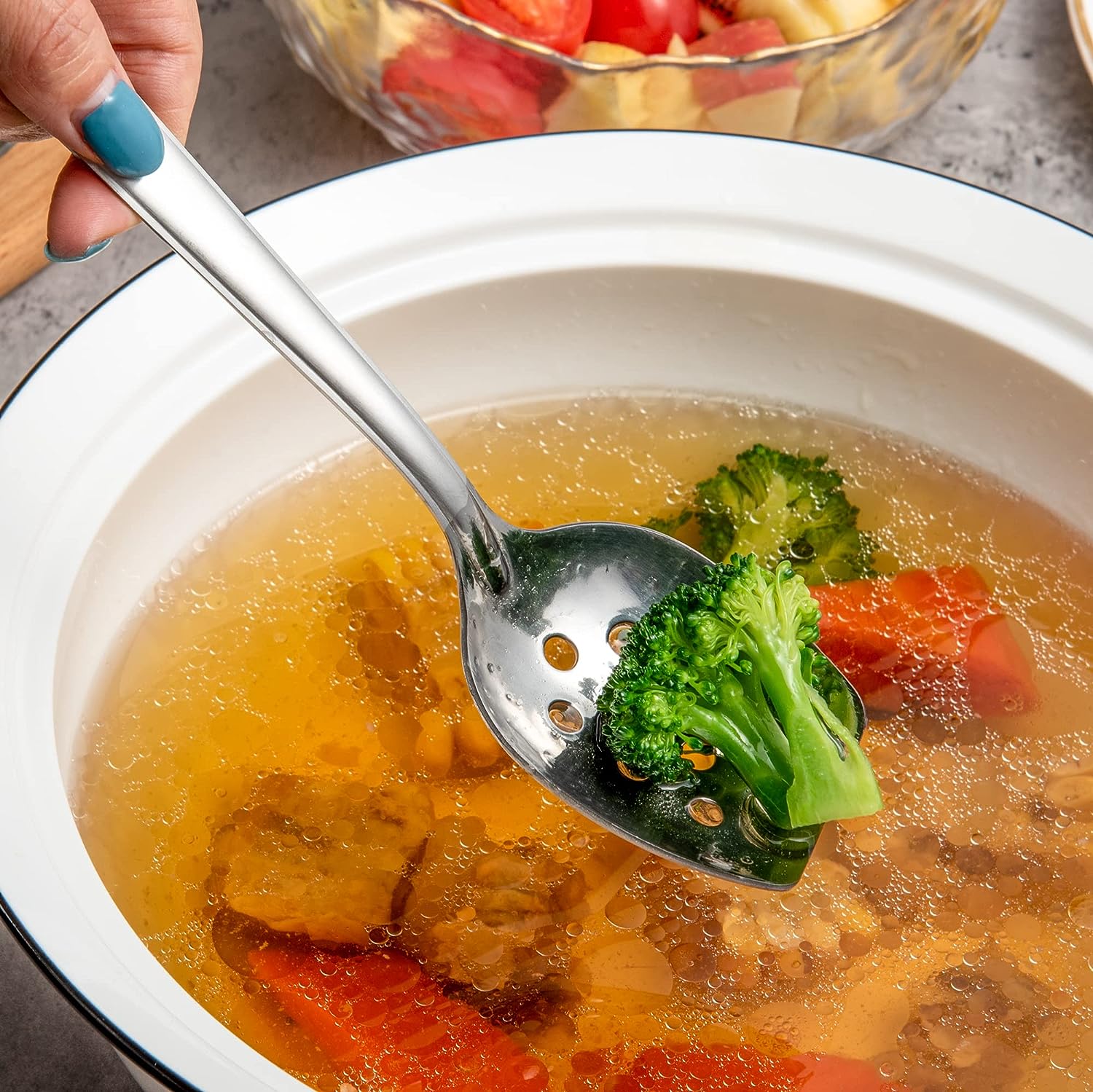 IMEEA Slotted Spoon lifting vegetables from soup with a perforated bowl design for easy draining