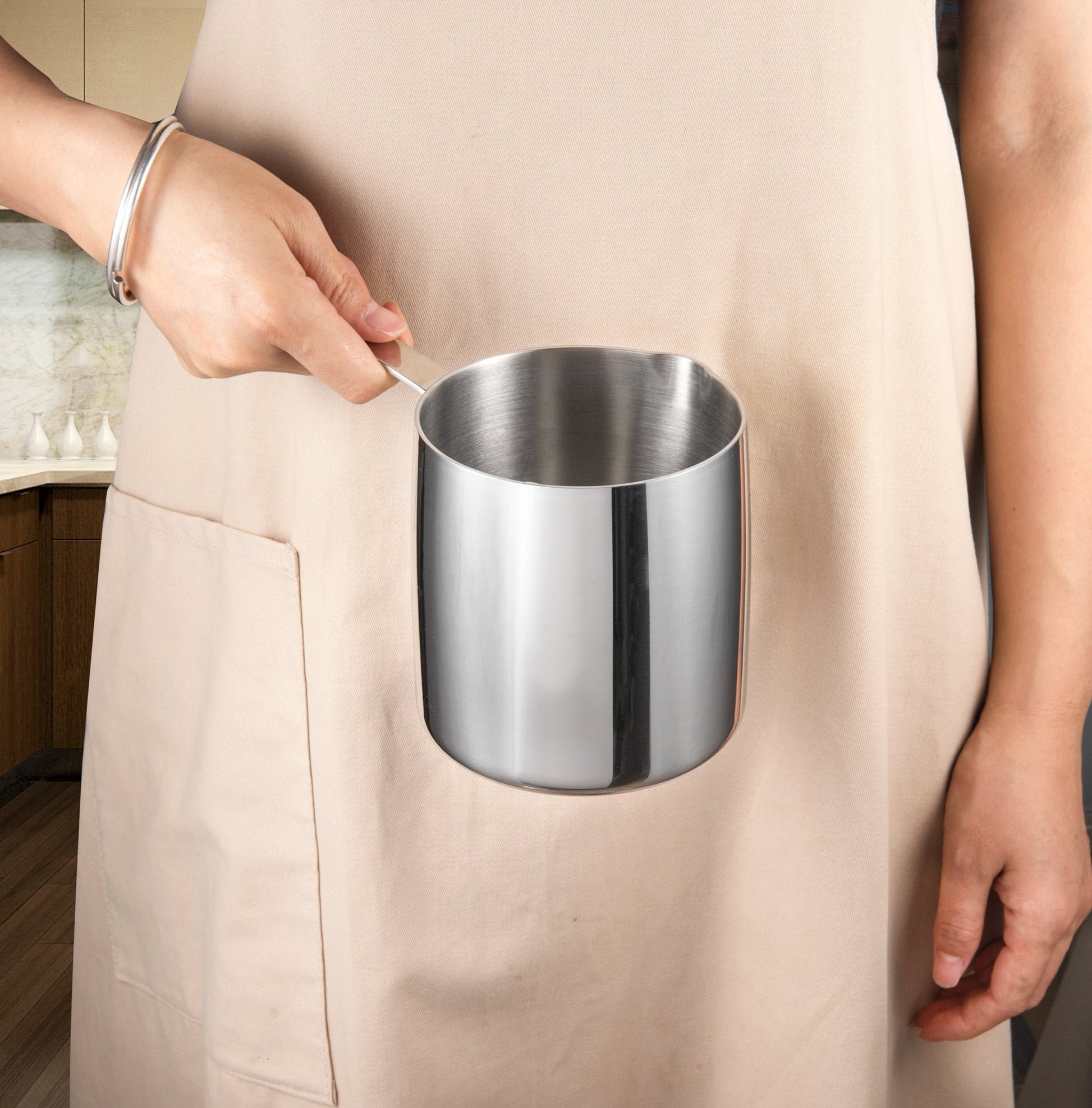 IMEEA Stainless Steel Butter Warmer with Pouring Spout shown in hand for compact kitchen use