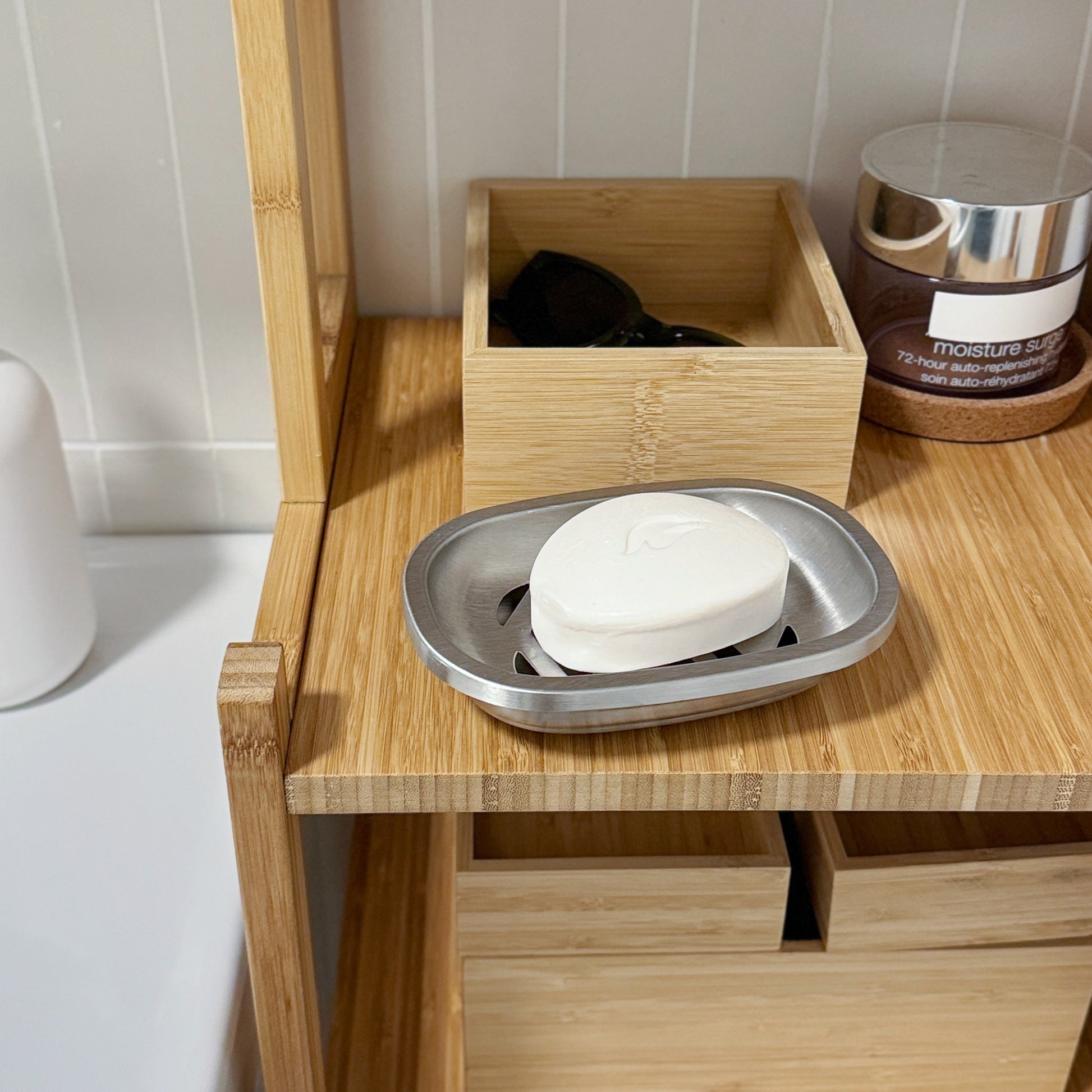 Brushed Stainless Steel Soap Dish with bar soap displayed on a wooden shelf near the bathroom sink