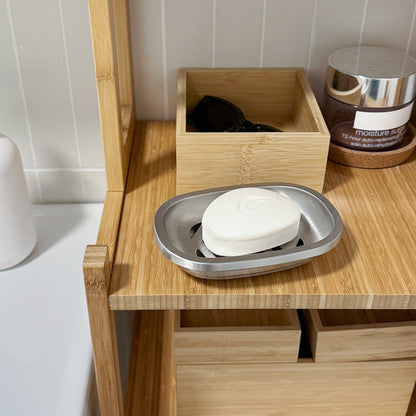 Brushed Stainless Steel Soap Dish with bar soap displayed on a wooden shelf near the bathroom sink