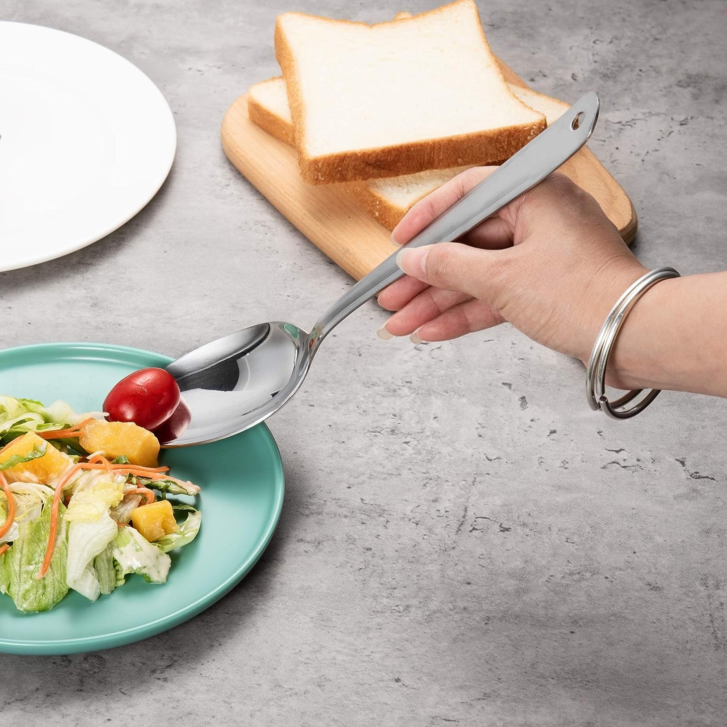 Smooth 18/8 Stainless Steel Solid Serving Spoon used for serving salad at the dining table