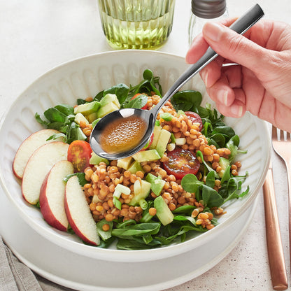 Comfortable Grip Stainless Steel Spoon held in hand above food