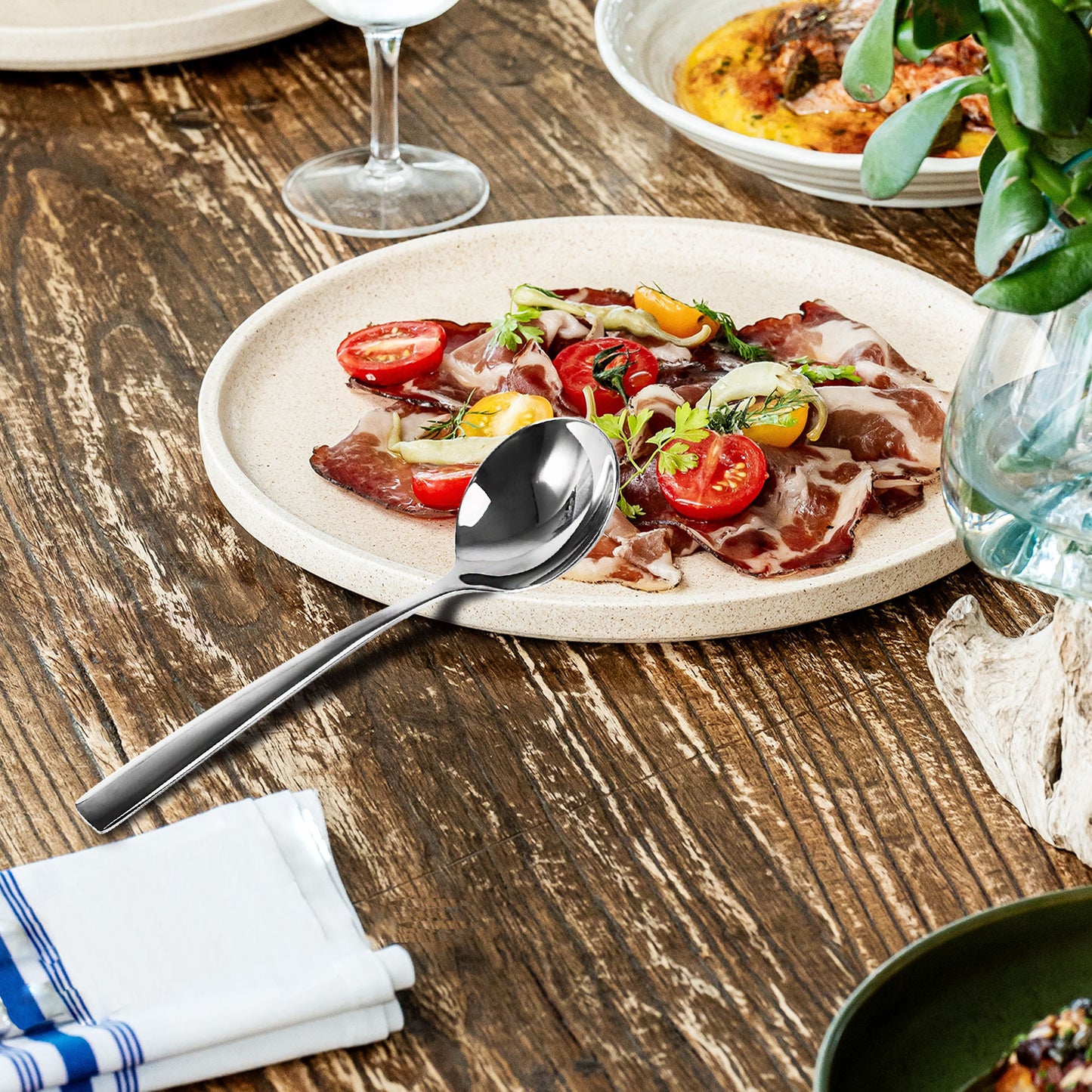 IMEEA 18/10 Stainless Steel Spoon resting beside a serving plate