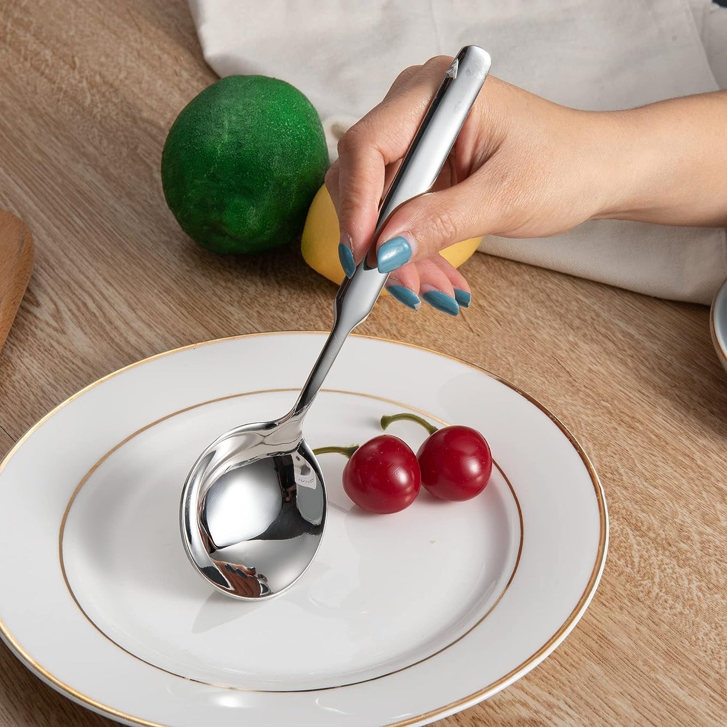 IMEEA 316 Stainless Steel Round Bowl soup Spoon held by hand over a plate