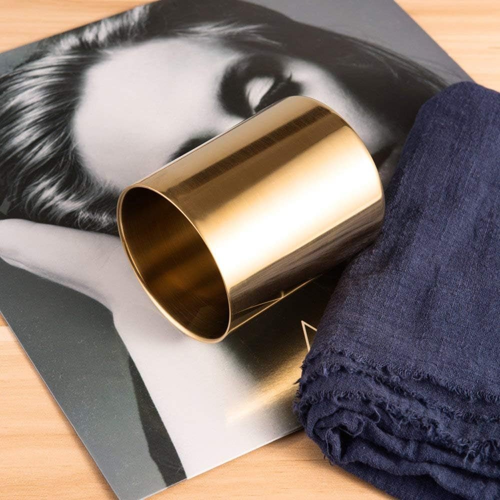 Minimalist gold makeup brush holder displayed horizontally on a desk display
