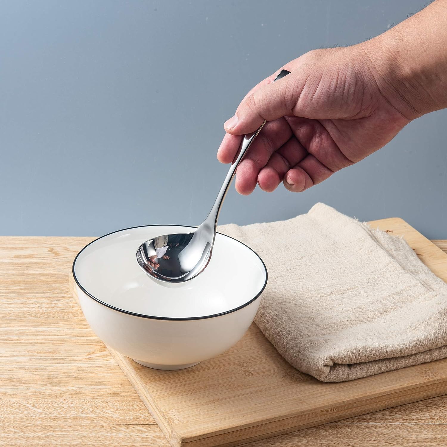 IMEEA small sauce ladle in a bowl with a deep bowl design for efficient sauce serving