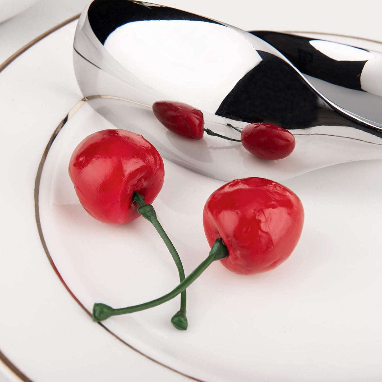 IMEEA Salad Servers 18/10 Stainless Steel with mirror polished finish reflecting light beside fresh cherries