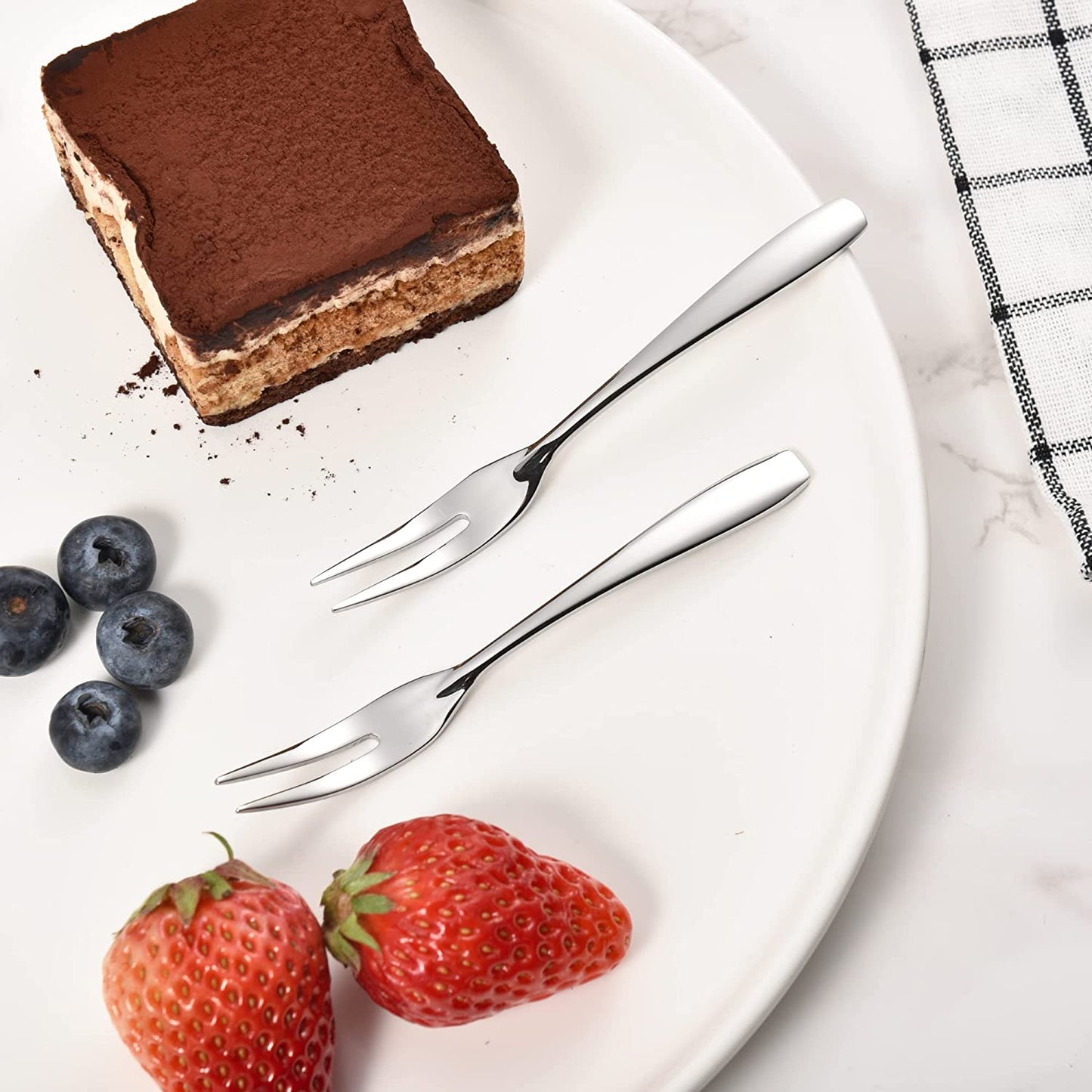 IMEEA Mini Cocktail Forks with polished 18/10 Stainless Steel finish on a dessert plate
