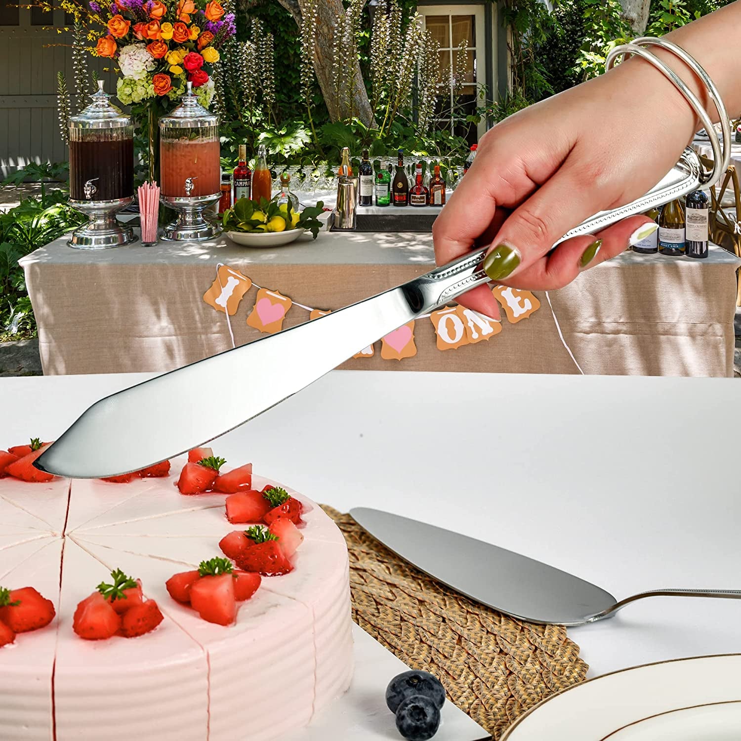 IMEEA cake knife positioned against a cake, showcasing the elegant stainless steel design for dessert serving