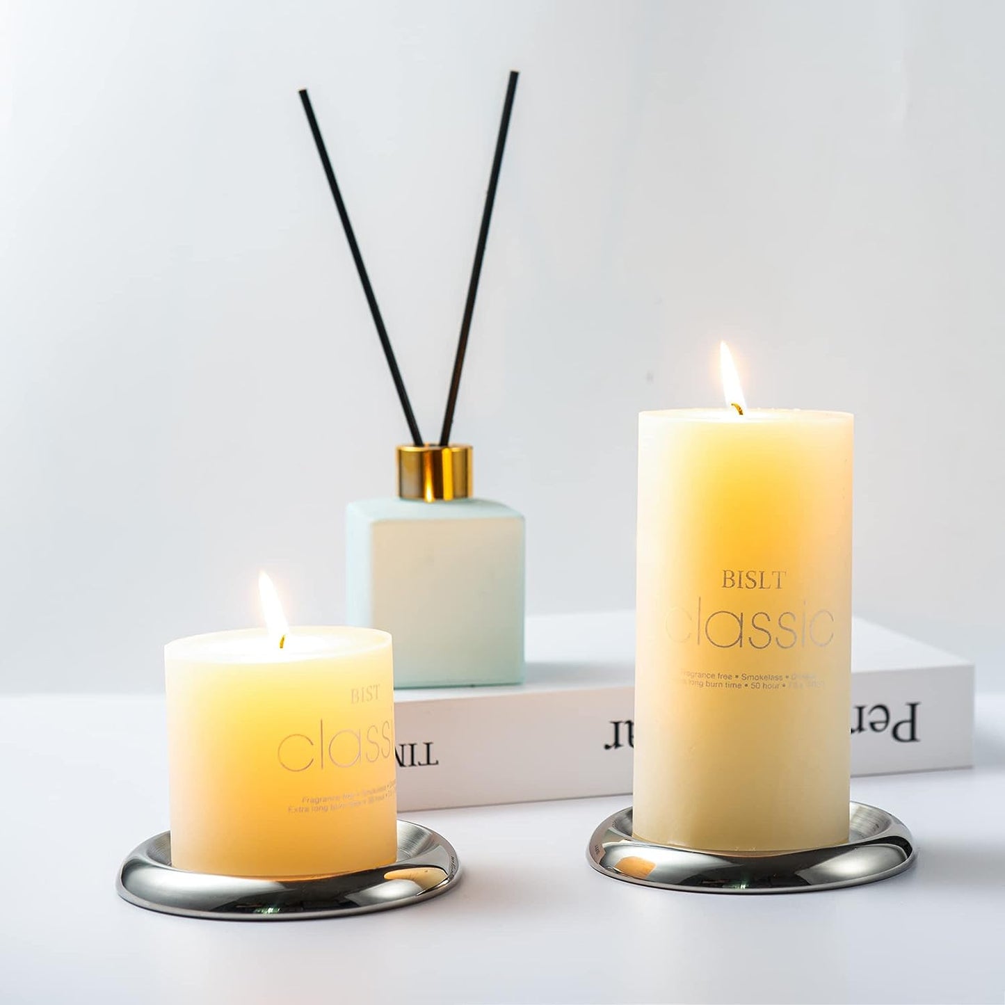 Stainless Steel Candle Holder Plate set of 2 with pillar candles on tabletop