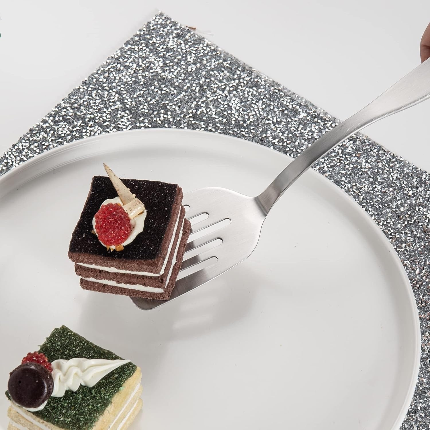 Elegant Stainless Steel Mini Dessert Spatula lifting a small cake from a serving plate