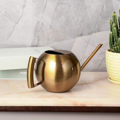 Bronze Stainless Steel Watering Can placed on a tabletop, showcasing its refined design as a stylish addition to home decor