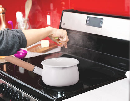 Enamel saucepan being used on a stovetop with a wooden handle and dual pour spouts