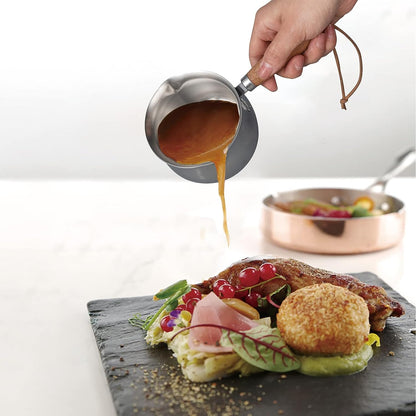 IMEEA Mini Stainless Steel Sauce Pan pouring sauce onto a dish on a dining table