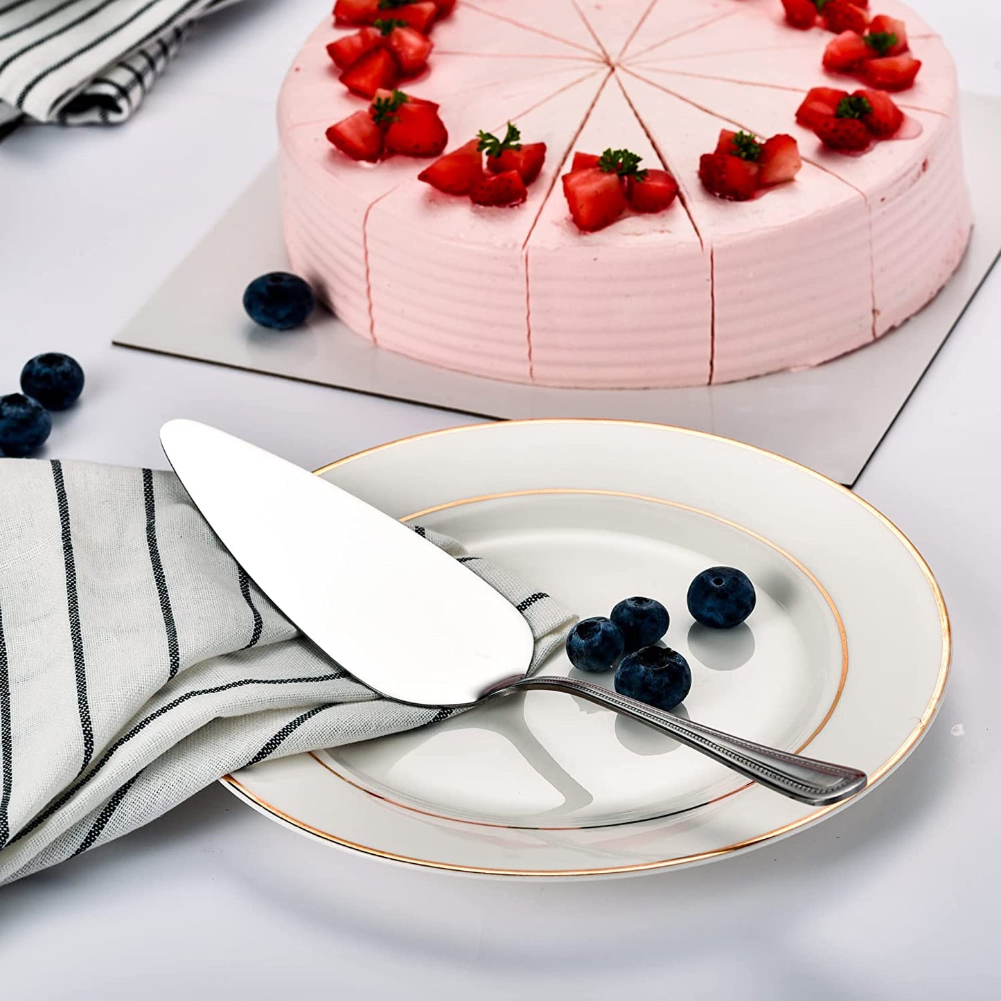 IMEEA cake server displayed in a serving plate with blueberries on a table