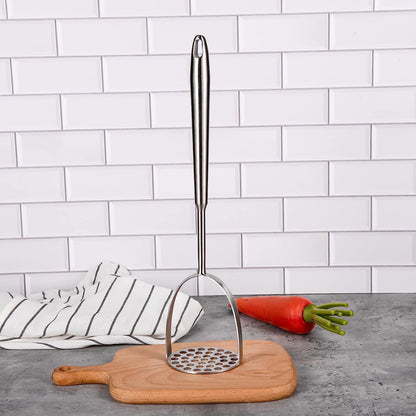 Long Handle Stainless Steel Potato Masher standing upright on a cutting board