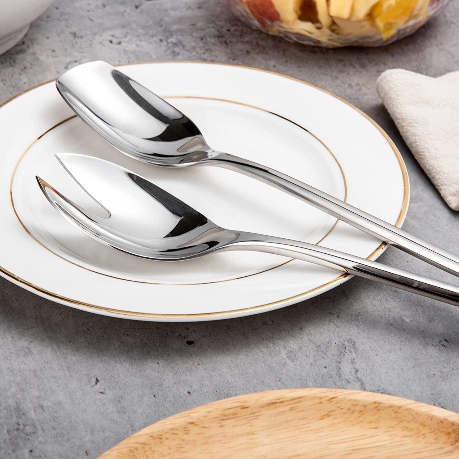 Elegant IMEEA Salad Servers 18/10 Stainless Steel spoon and fork set displayed on a plate