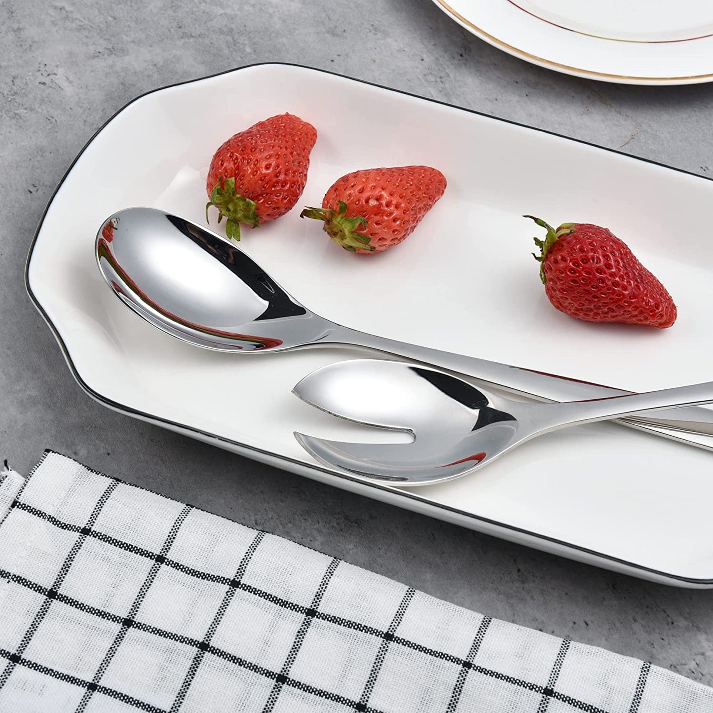 Stainless Steel Salad Servers displayed with a strawberry dish for elegant table presentation
