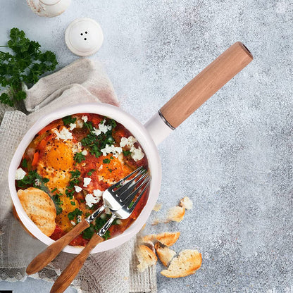 Enamel saucepan with food inside, wooden handle, and dual pour spouts for daily cooking