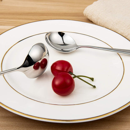 Stainless Steel Soup Spoon with a reflective polished finish placed beside cherries on a dining plate