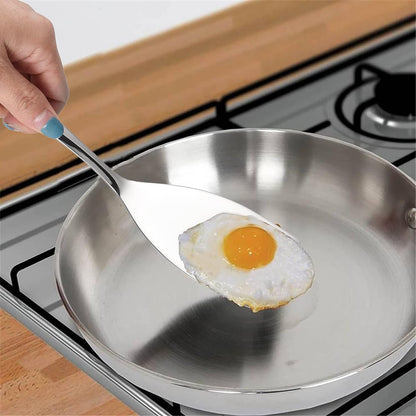 IMEEA Small Spatula used for lifting eggs from a frying pan on a stovetop