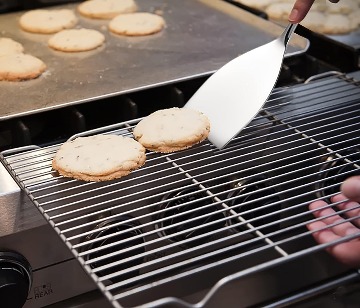 IMEEA Small Stainless Steel Turner flipping a cooked meat patty, showcasing its practical cooking use