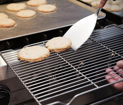 IMEEA Small Stainless Steel Turner flipping a cooked meat patty, showcasing its practical cooking use