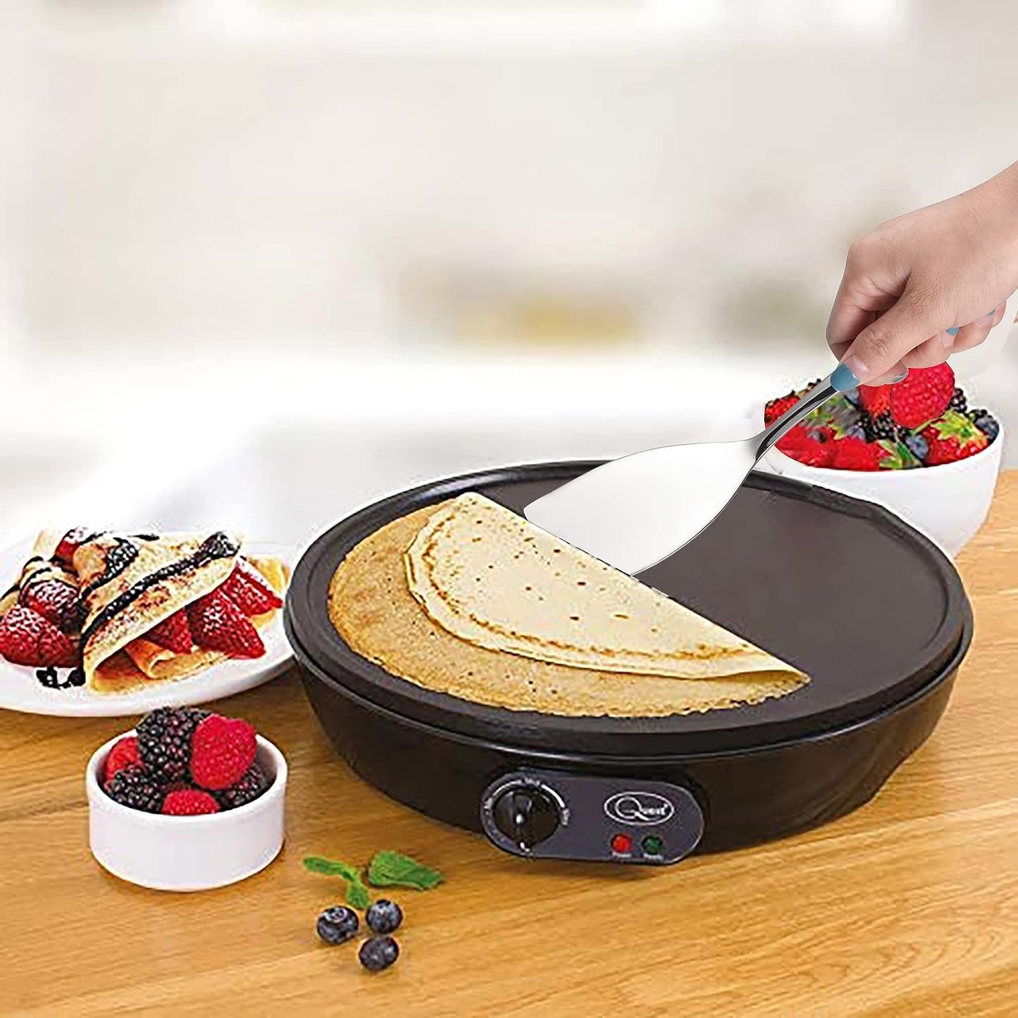 IMEEA Small Stainless Steel Turner lifting a pancake from a pancake pan, showcasing practical cooking use