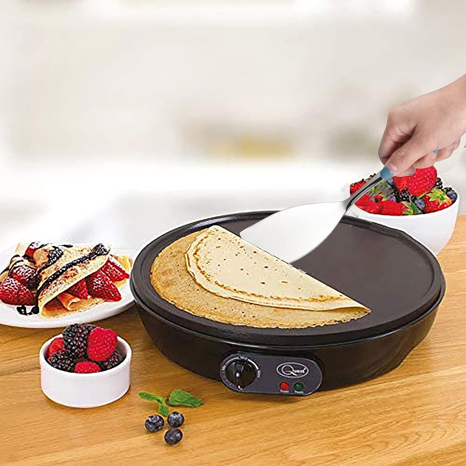 IMEEA Small Stainless Steel Turner lifting a pancake from a pancake pan, showcasing practical cooking use