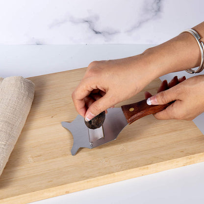 Stainless Steel Truffle Slicer shaving truffles on a kitchen cutting board