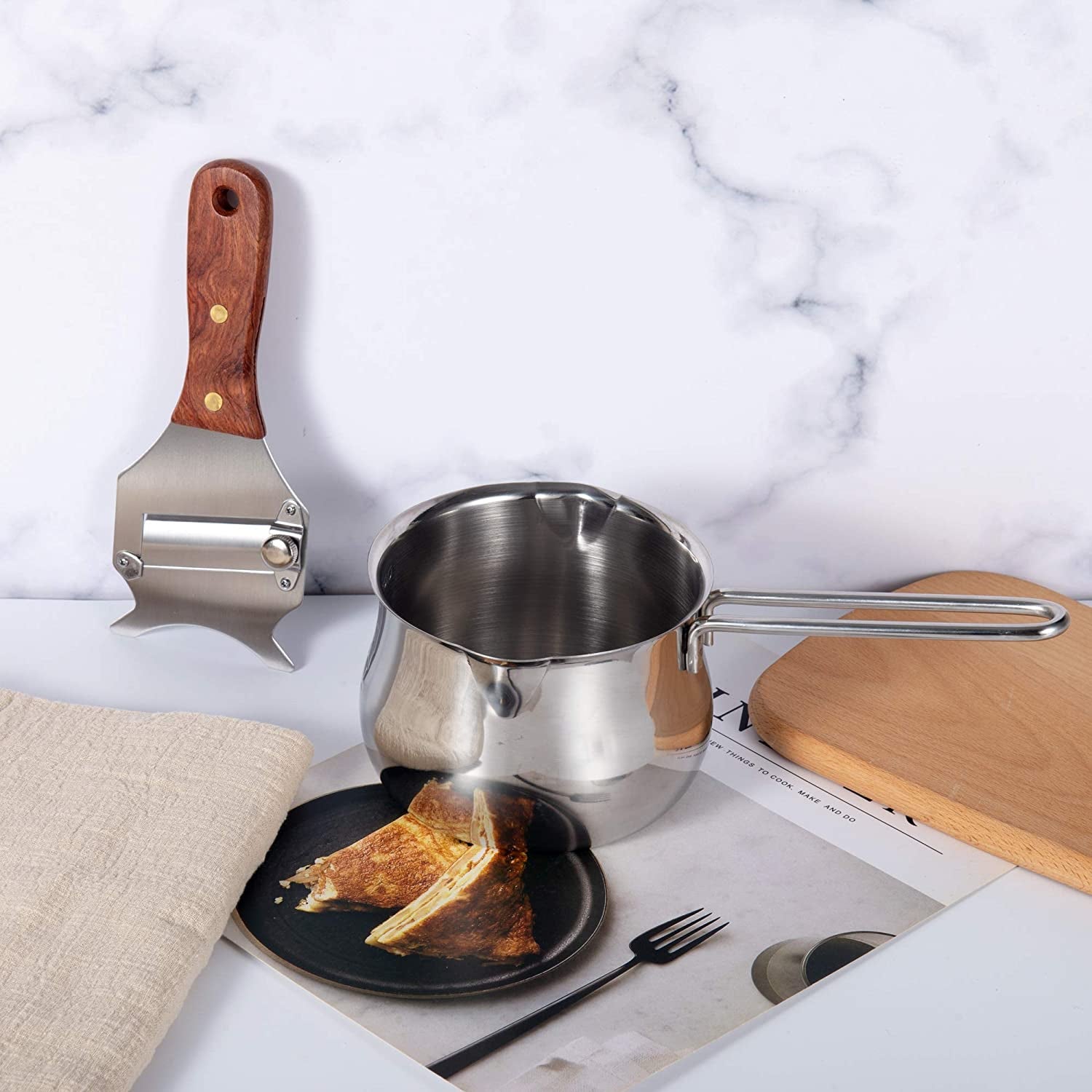 Multi-Functional Stainless Steel Truffle Slicer with Wood Handle on a kitchen countertop with other utensils